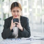 Portrait of an Asian girl Talking to customers on smartphones in the modern office